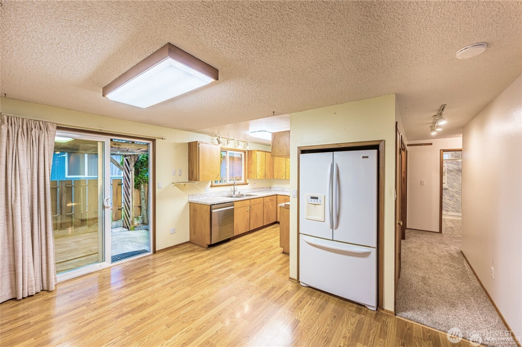 1030 11th Street Port Townsend, WA 98368 - Photo 6 of 21 a kitchen with stainless steel appliances a refrigerator and a stove top oven