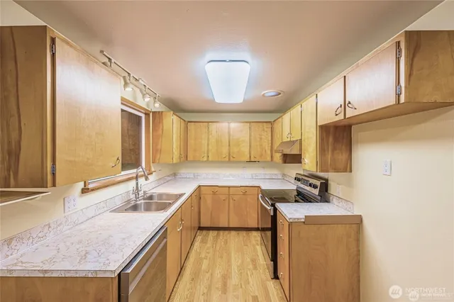 a kitchen with a sink appliances and cabinets