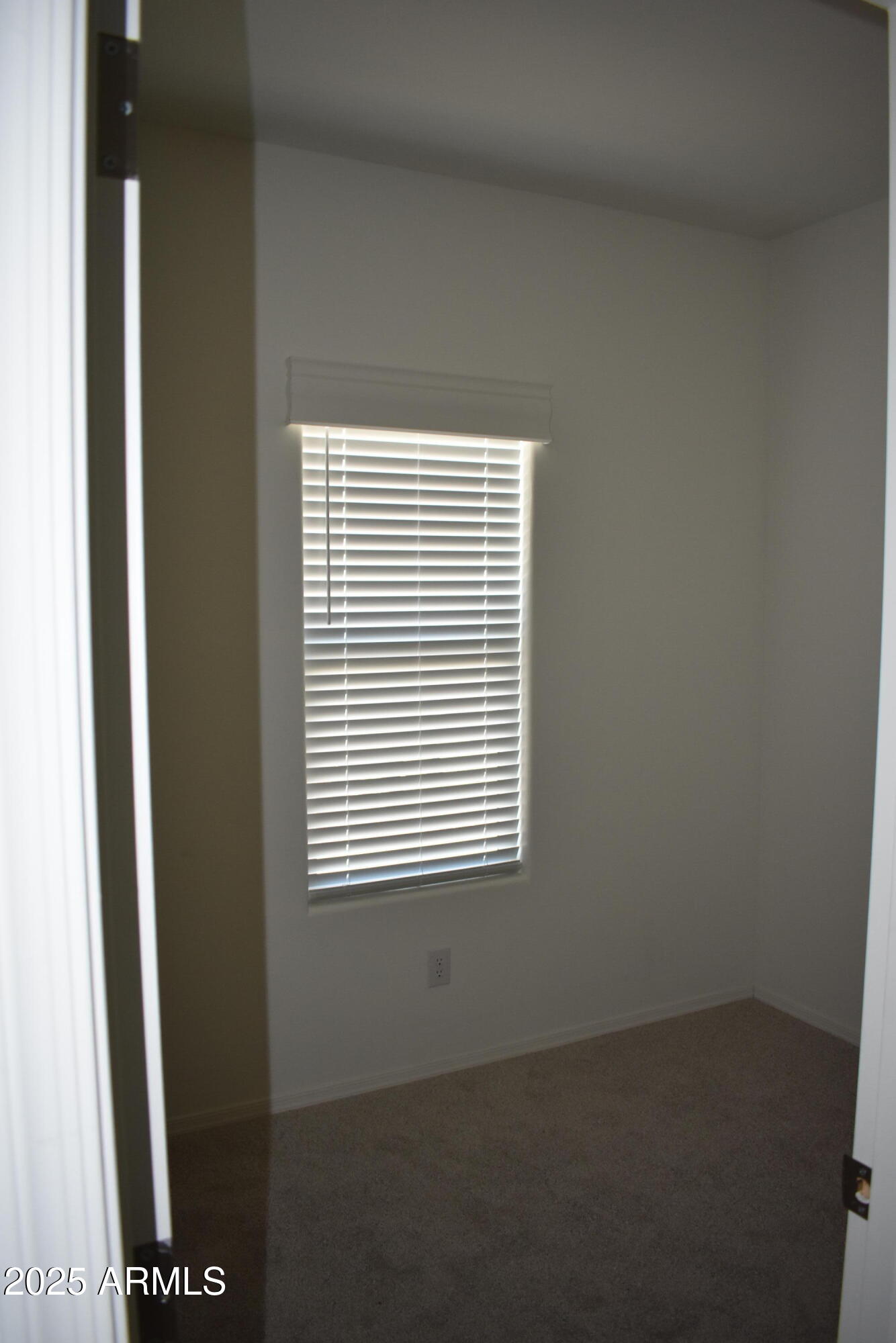620 West Limberlost Drive, Unit E3 Tucson, AZ 85705 - Photo 9 of 17 a view of an empty room with a window