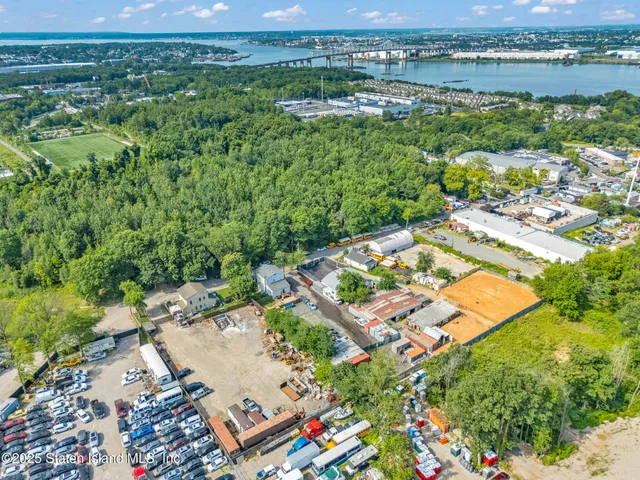 an aerial view of residential houses with outdoor space and river