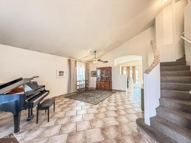 a view of a livingroom with wooden floor and stairs