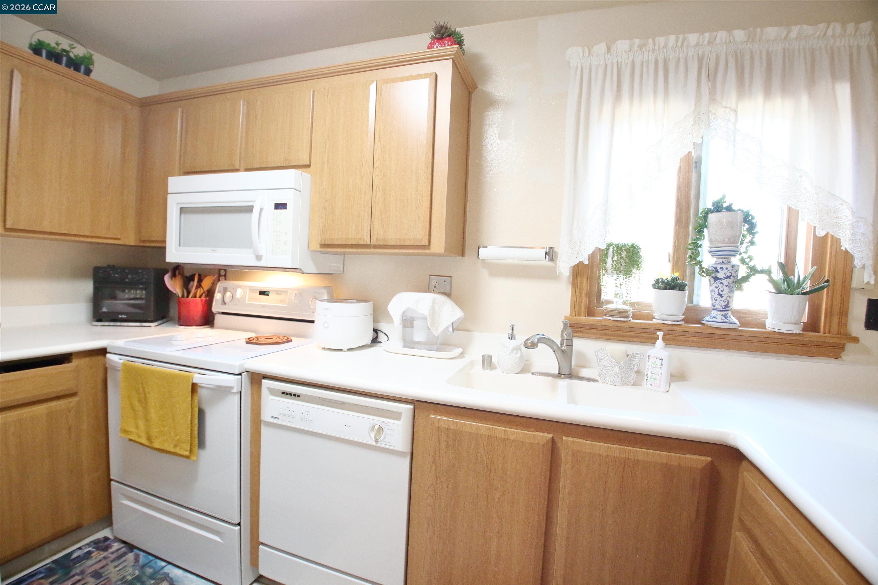 3901 Clayton Road, Unit 25 Concord, CA 94521 - Photo 6 of 28 a kitchen with a sink cabinets and window