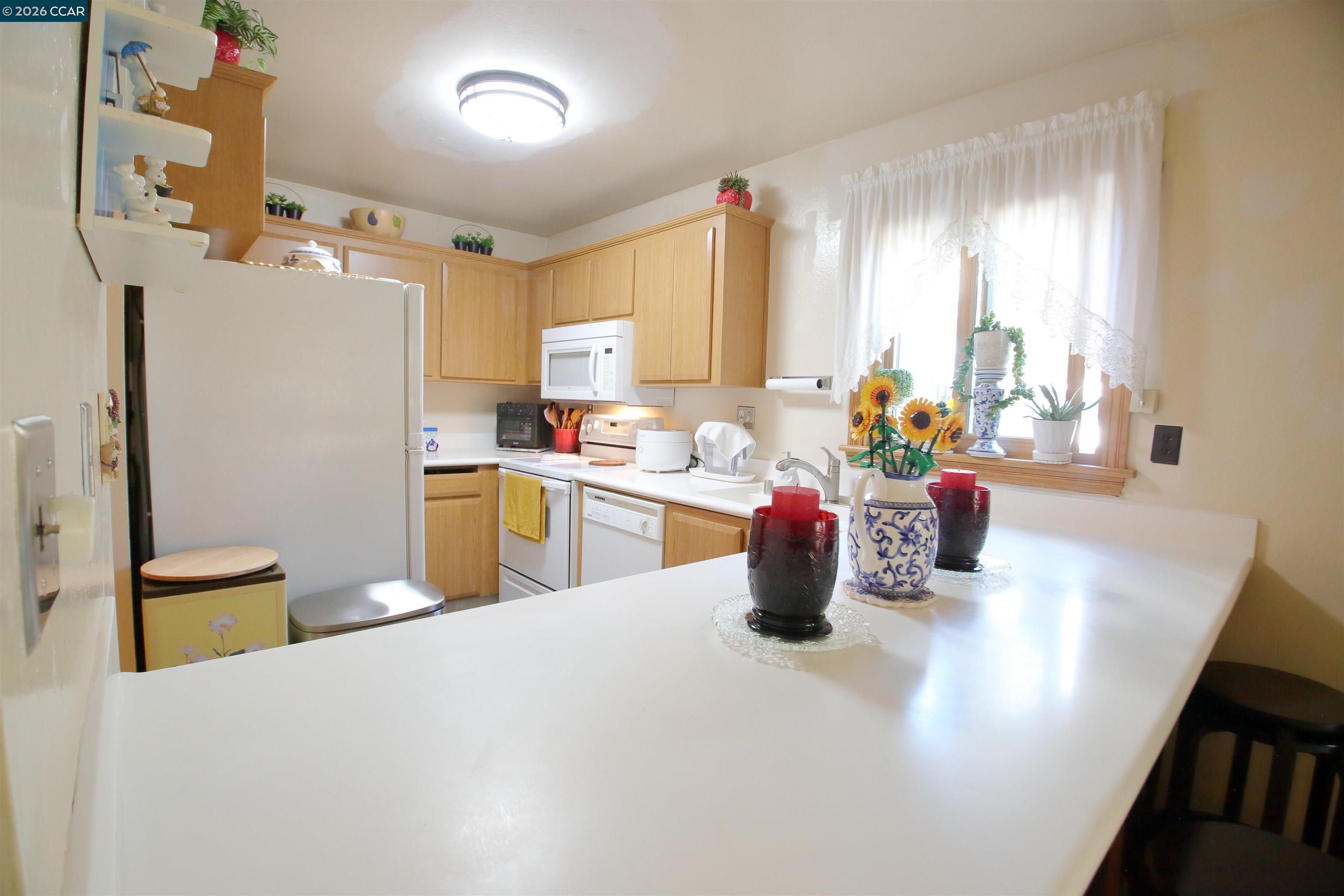 3901 Clayton Road, Unit 25 Concord, CA 94521 - Photo 7 of 28 a kitchen with sink refrigerator and window