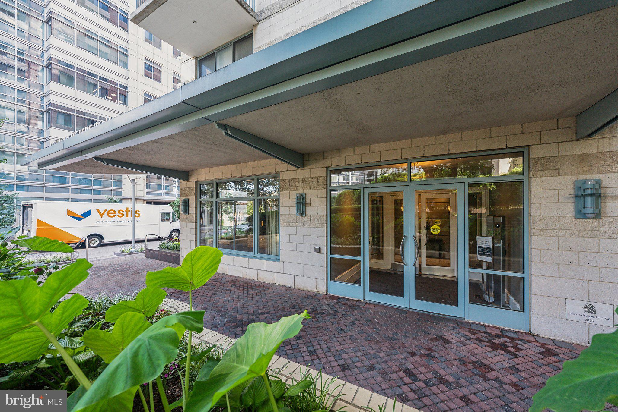 851 North Glebe Road, Unit 2008 Arlington, VA 22203 - Photo 23 of 37 Modern entrance with lush greenery.
