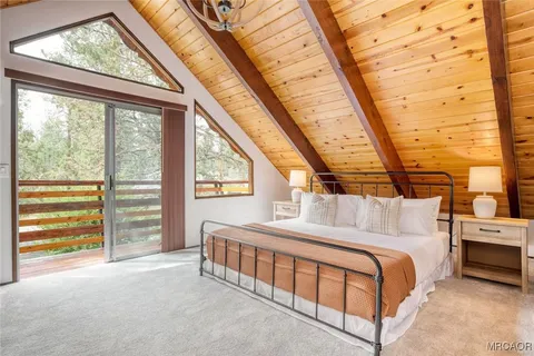 a bedroom with a bed and a large window