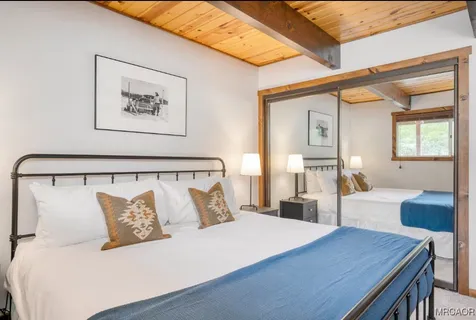 a bedroom with a large bed and a chandelier