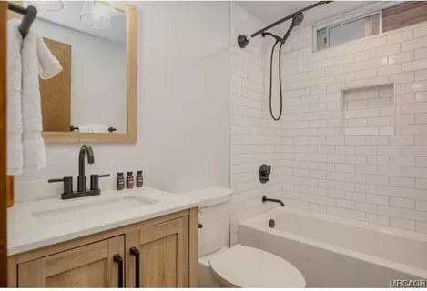 a bathroom with a sink a toilet and a bathtub