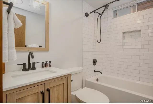 a bathroom with a sink a toilet and a bathtub