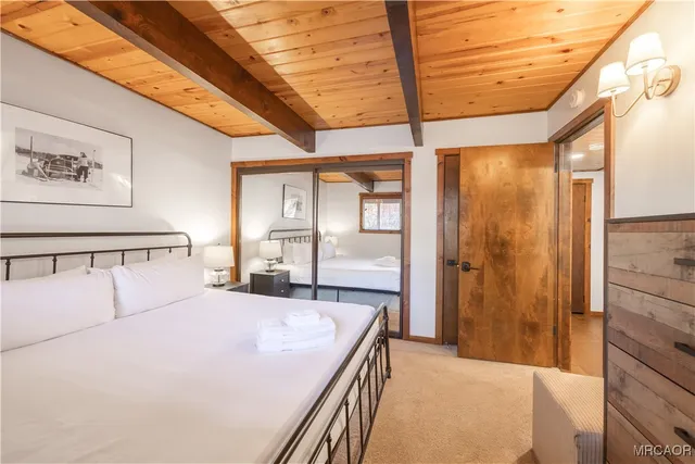 a bedroom with a large bed and a chandelier