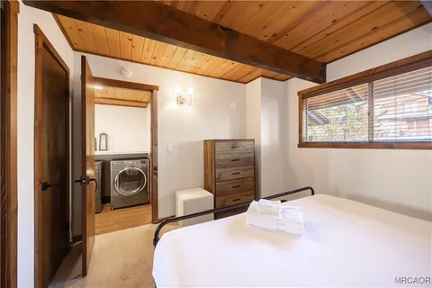 a bedroom with bed and a chandelier