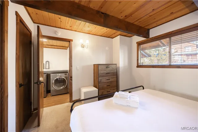 a bedroom with bed and a chandelier