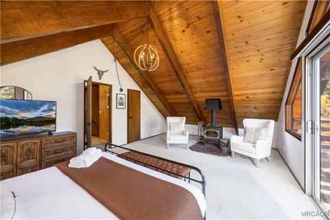 a bedroom with furniture and a flat screen tv