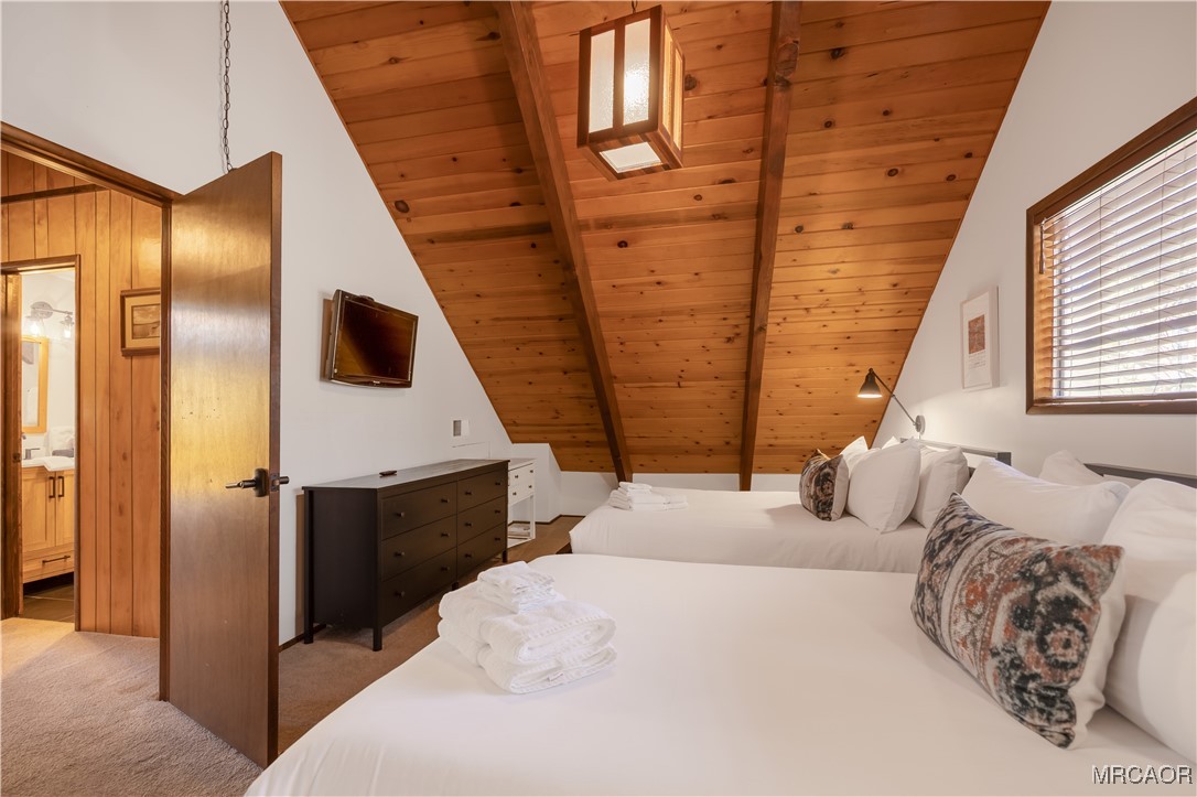 42535 Avalon Road Big Bear Lake, CA 92315 - Photo 32 of 39 a bedroom with a bed and a mirror