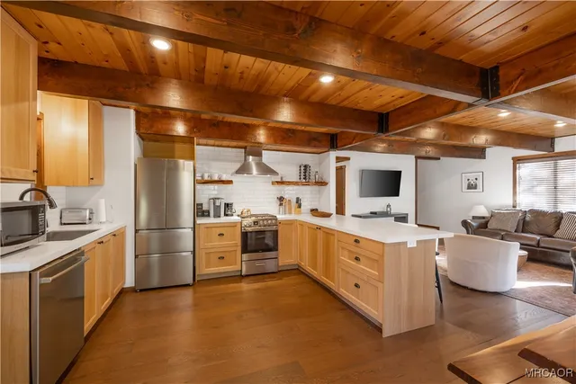 a kitchen with stove a sink and refrigerator