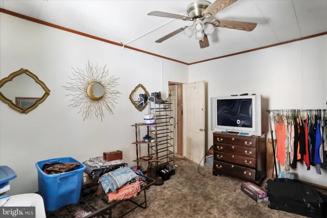 a bedroom with furniture and a flat screen tv
