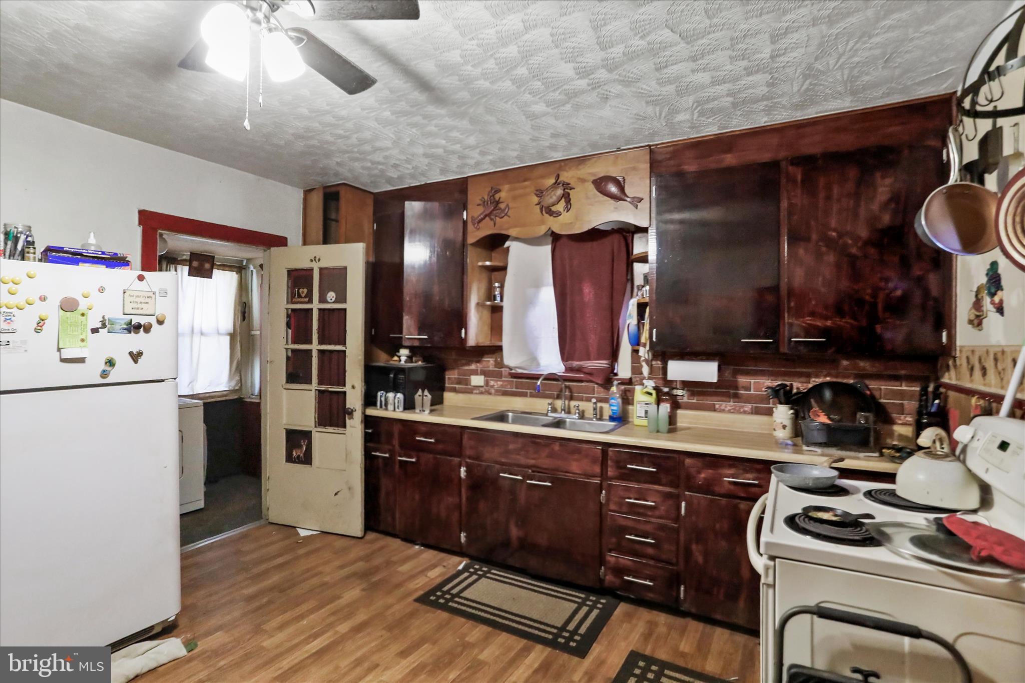 301 Poplar Street Westernport, MD 21562 - Photo 9 of 22 a kitchen with a refrigerator and a sink