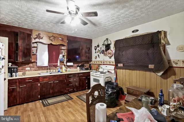 a kitchen with stainless steel appliances kitchen island granite countertop a stove and cabinets