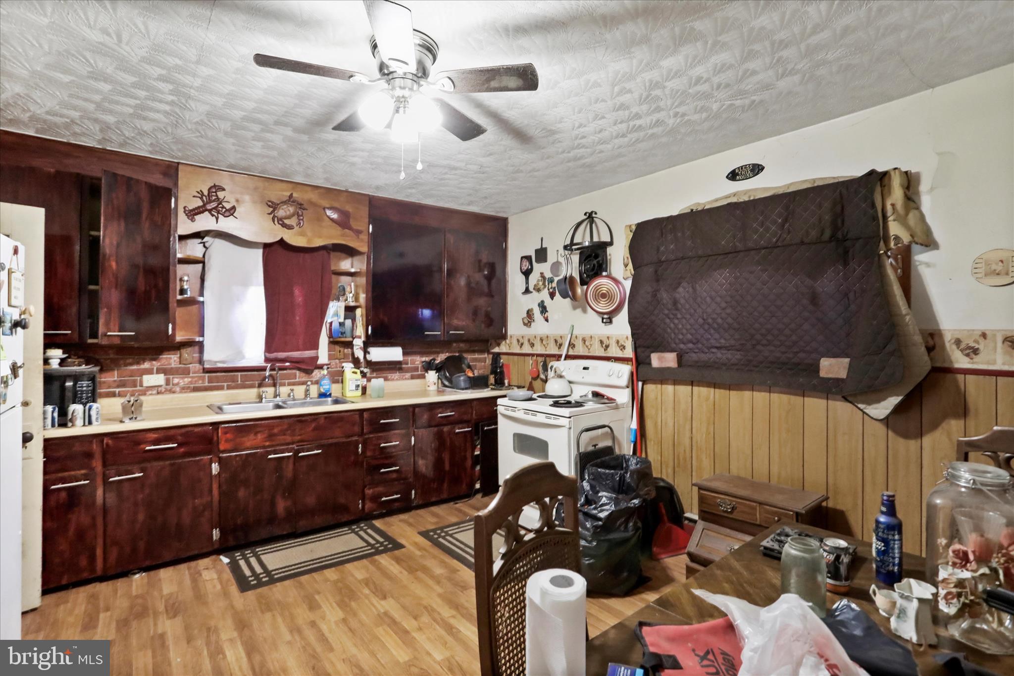 301 Poplar Street Westernport, MD 21562 - Photo 10 of 22 a kitchen with stainless steel appliances kitchen island granite countertop a stove and cabinets