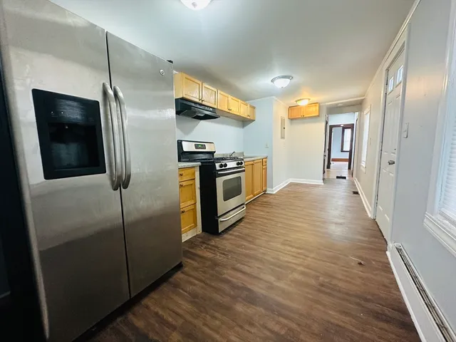 a kitchen with stainless steel appliances granite countertop a refrigerator and a sink