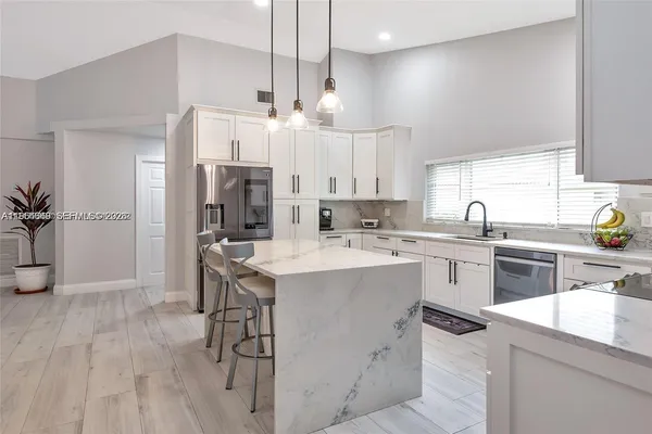 a kitchen with cabinets appliances and a sink