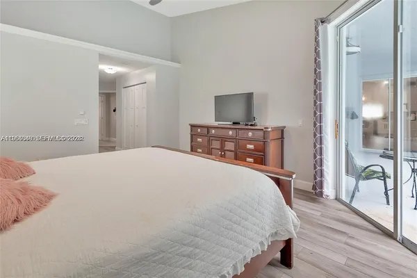 a bedroom with a bed and a potted plant