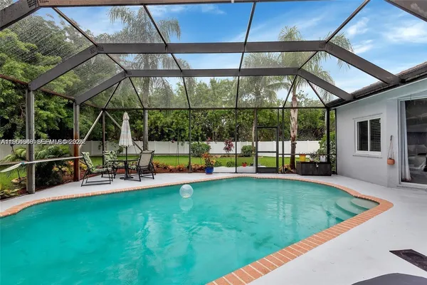 a living room with furniture dining table and a chandelier