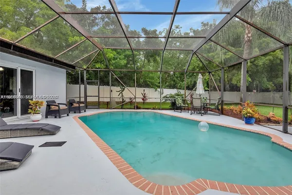 an aerial view of residential house with outdoor space and swimming pool