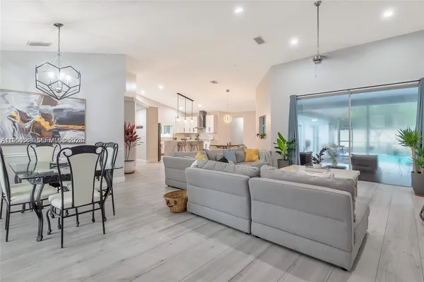 a living room with furniture and a chandelier