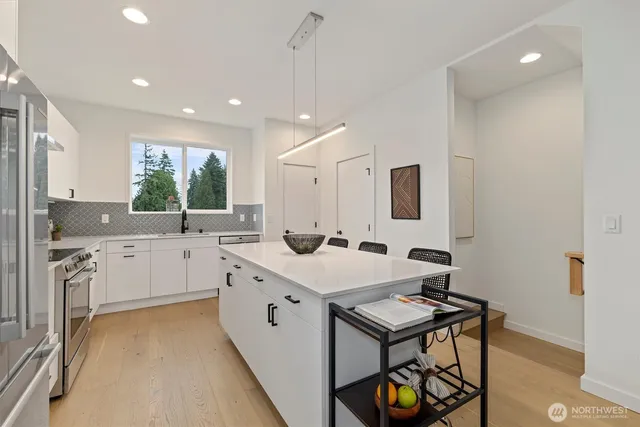 a kitchen with a sink appliances and cabinets