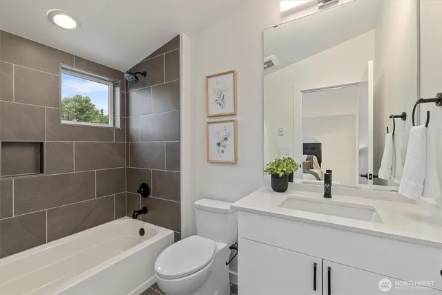 a bathroom with a sink mirror toilet and bathtub