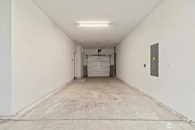 an empty room with a garage and windows