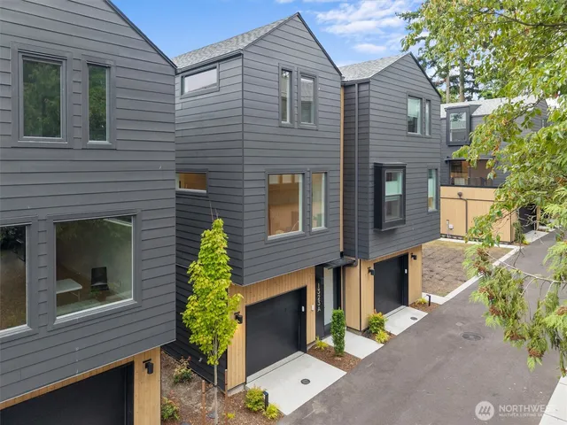 a brick house with a yard and potted plants