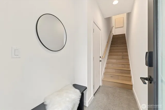 a view of a hallway with wooden floor and entryway