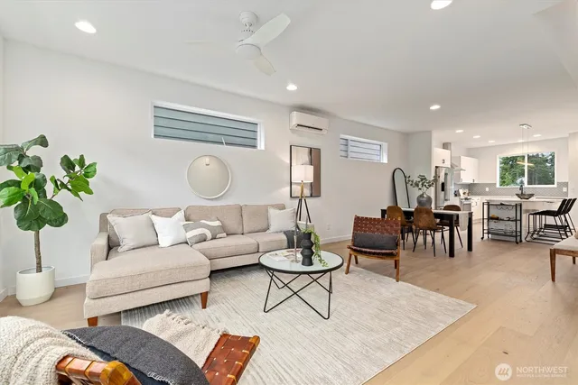 a living room with furniture potted plant and white walls