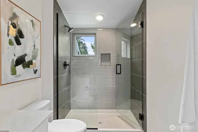 a bathroom with a shower and toilet