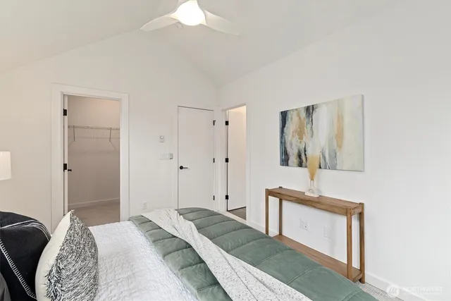 a spacious bedroom with a bed and a table