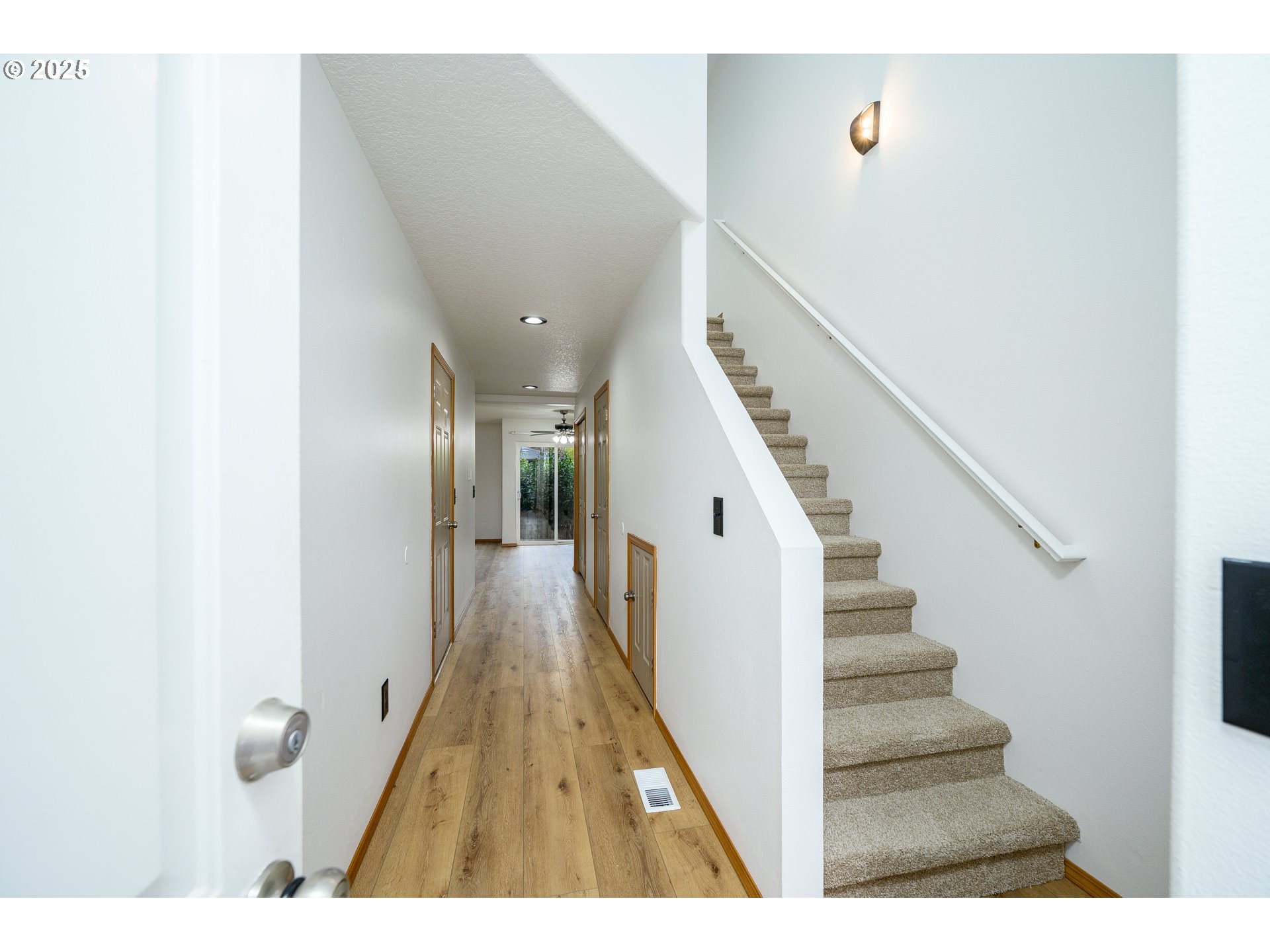 1306 Parkside Lane Newberg, OR 97132 - Photo 3 of 48 a view of a hallway with wooden floor and staircase