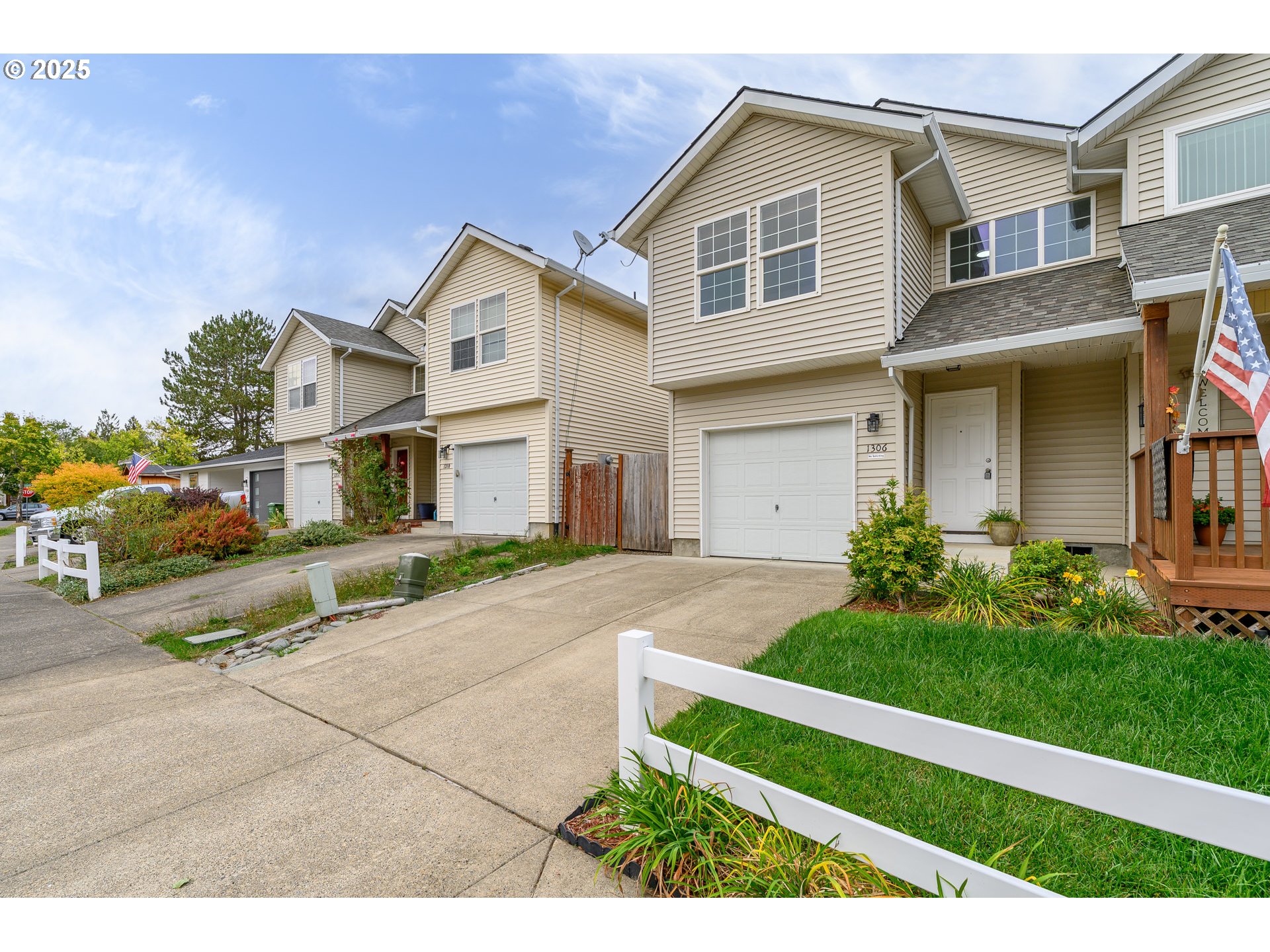 1306 Parkside Lane Newberg, OR 97132 - Photo 43 of 48 a view of a white house with a small yard and large trees