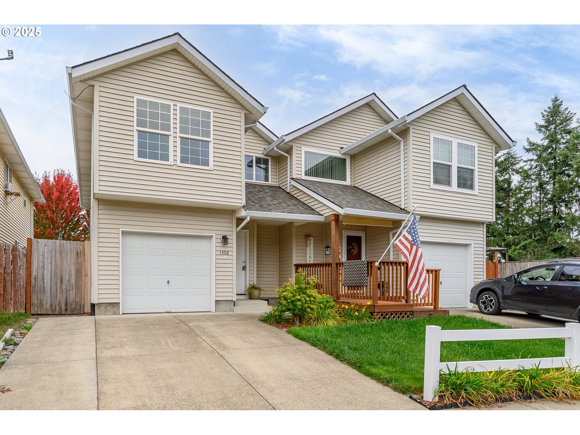 1306 Parkside Lane Newberg, OR 97132 - Photo 46 of 48 a view of a white house next to a yard and a large tree