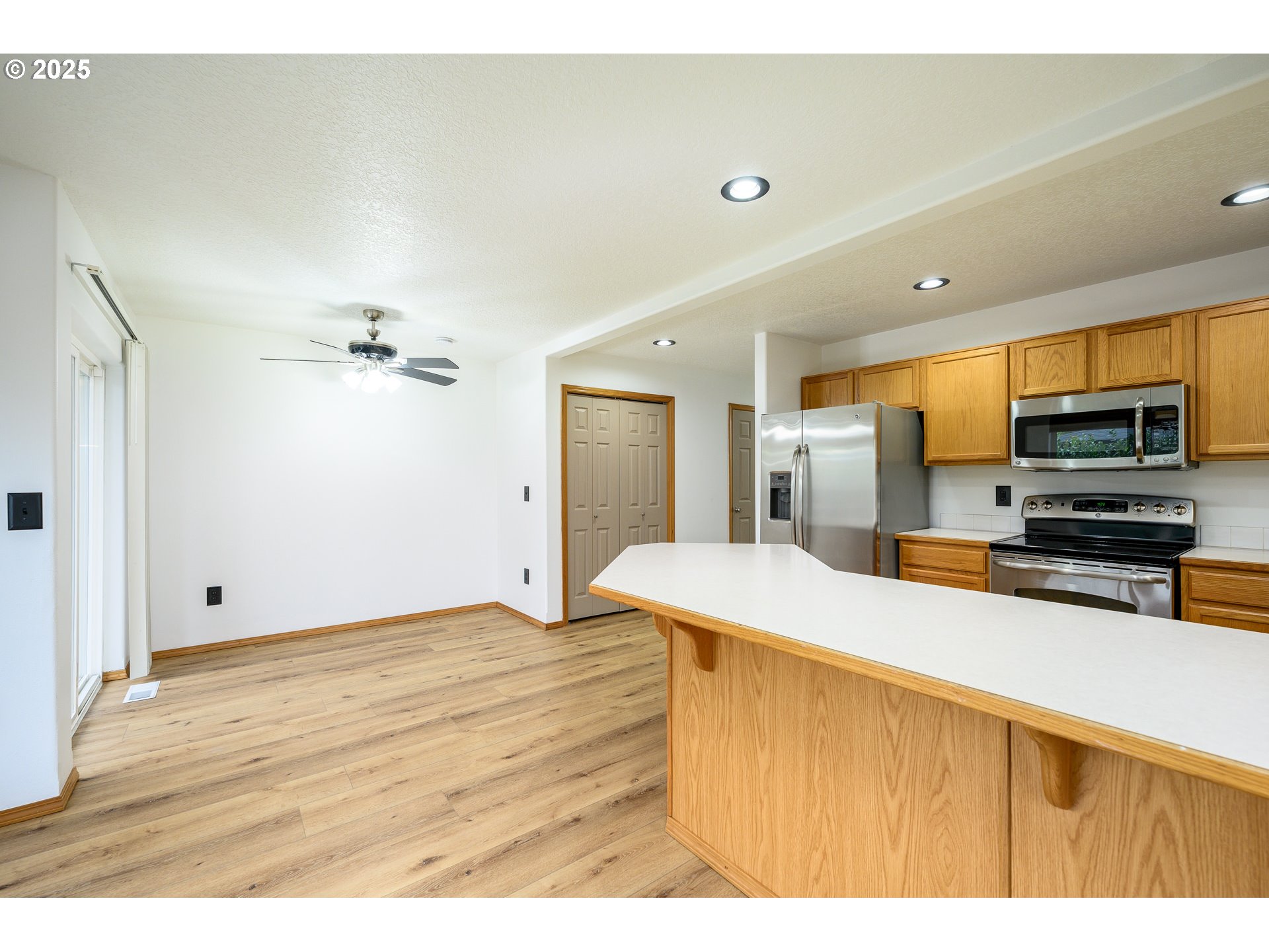1306 Parkside Lane Newberg, OR 97132 - Photo 8 of 48 a kitchen with stainless steel appliances kitchen island sink refrigerator and microwave