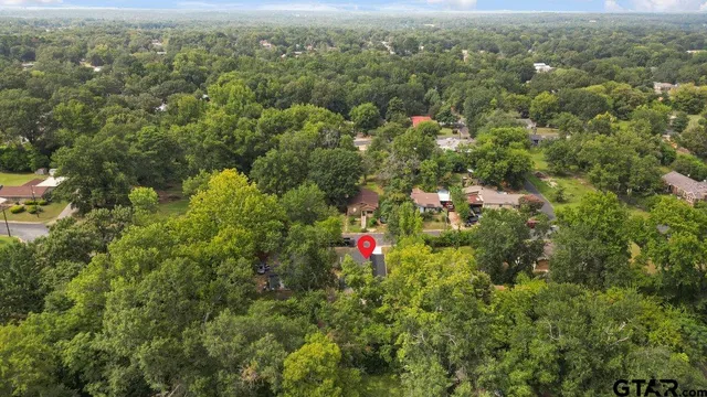 an aerial view of residential house with outdoor space and trees
