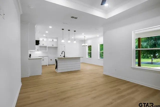 a view of kitchen with kitchen island refrigerator sink and window