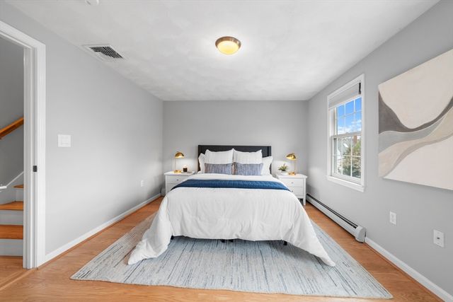 a bedroom with a bed and window