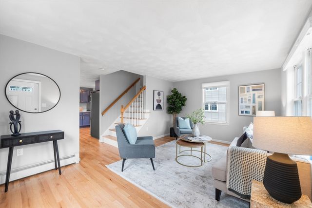 a living room with furniture a rug and a window