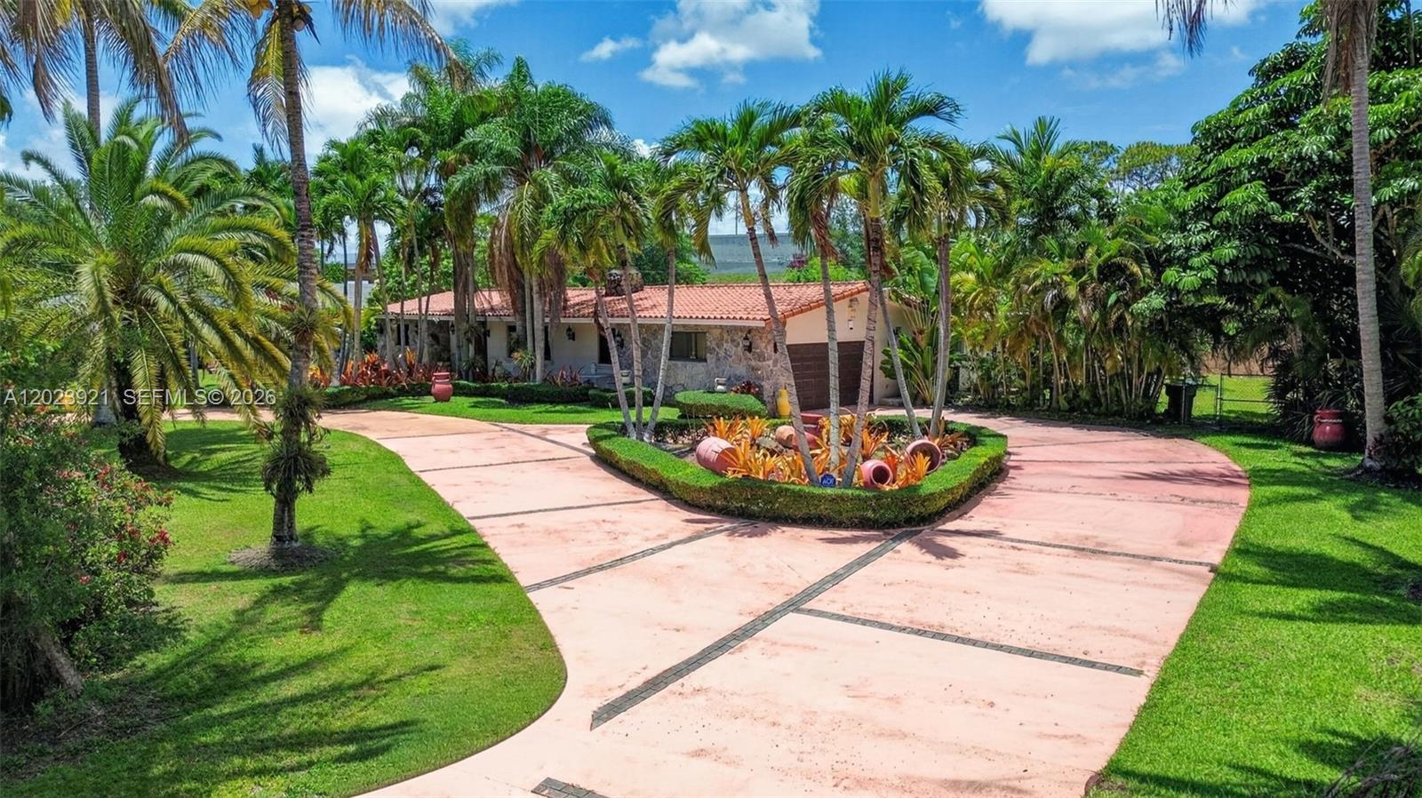8461 Southwest 68th St Road Miami, FL 33143 - Photo 6 of 65 a view of a swimming pool with a garden