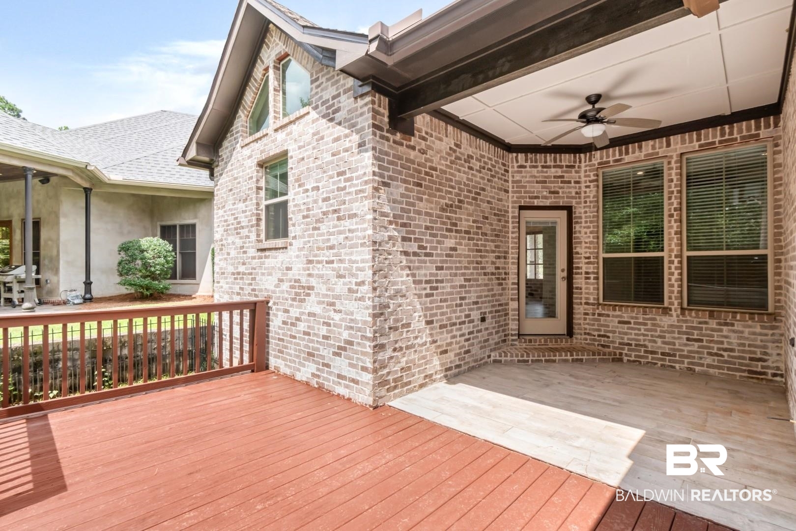 3528 Rue Royal Mobile, AL 36693 - Photo 46 of 53 Expansive outdoor living area featuring a wood-finish deck, a covered patio with a ceiling fan, and brick exterior walls