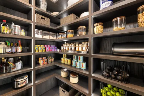 a bedroom with a bed and a large window with outer view