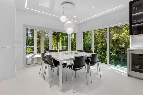 a large bed sitting in a bedroom next to a large window