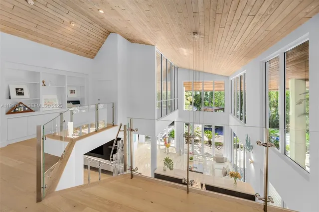 a view of swimming pool with seating space and trees in the background