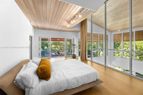 a white bath tub sitting in a bathroom next to a window